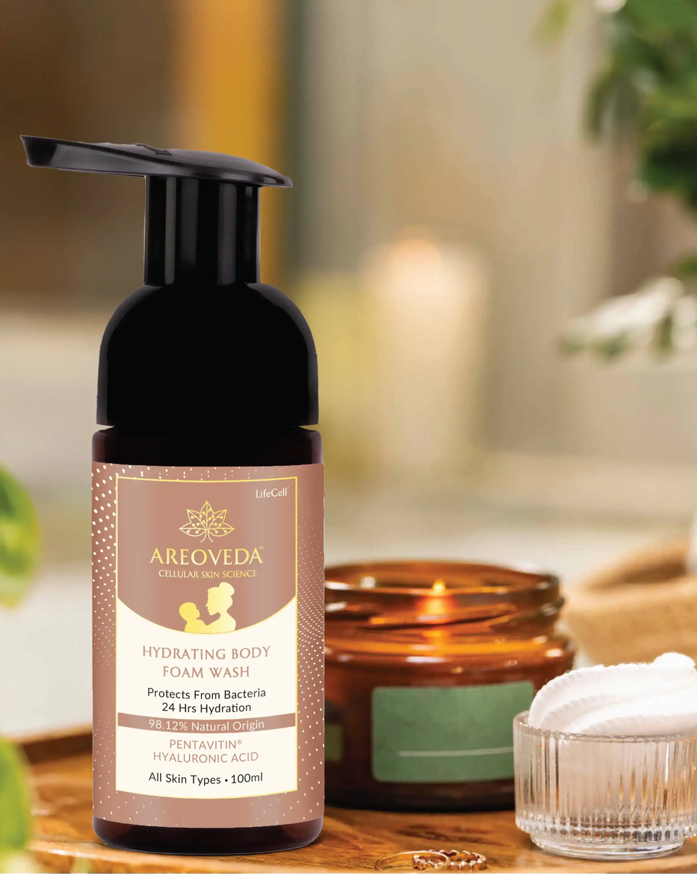 Areoveda hydrating body foam wash bottle on a wooden surface with blurred background